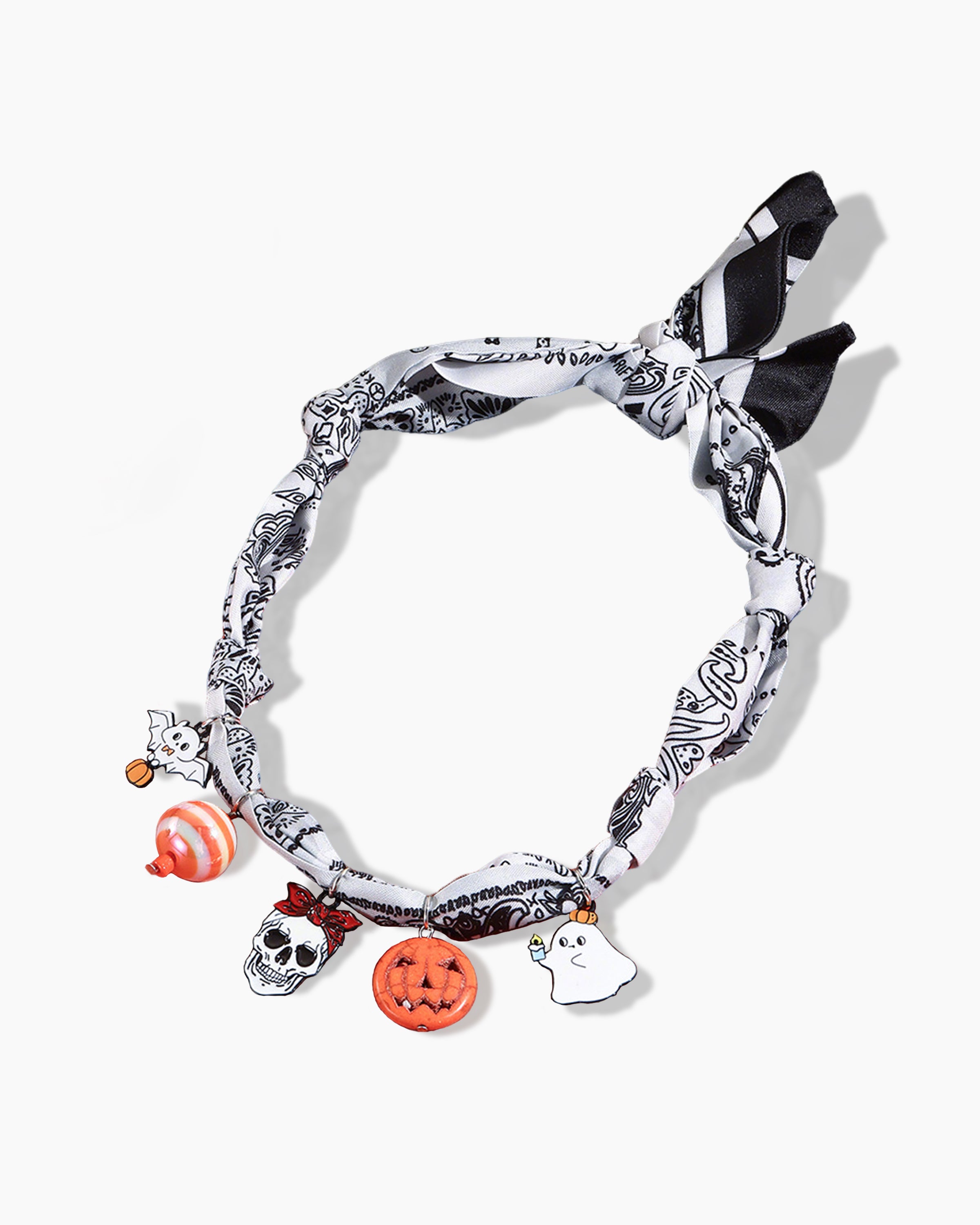 Close-up of Adjustable Pumpkin Purr Silk Cat Collar showing pumpkins, skulls, ghosts, and bats design – luxury silk cat accessory.