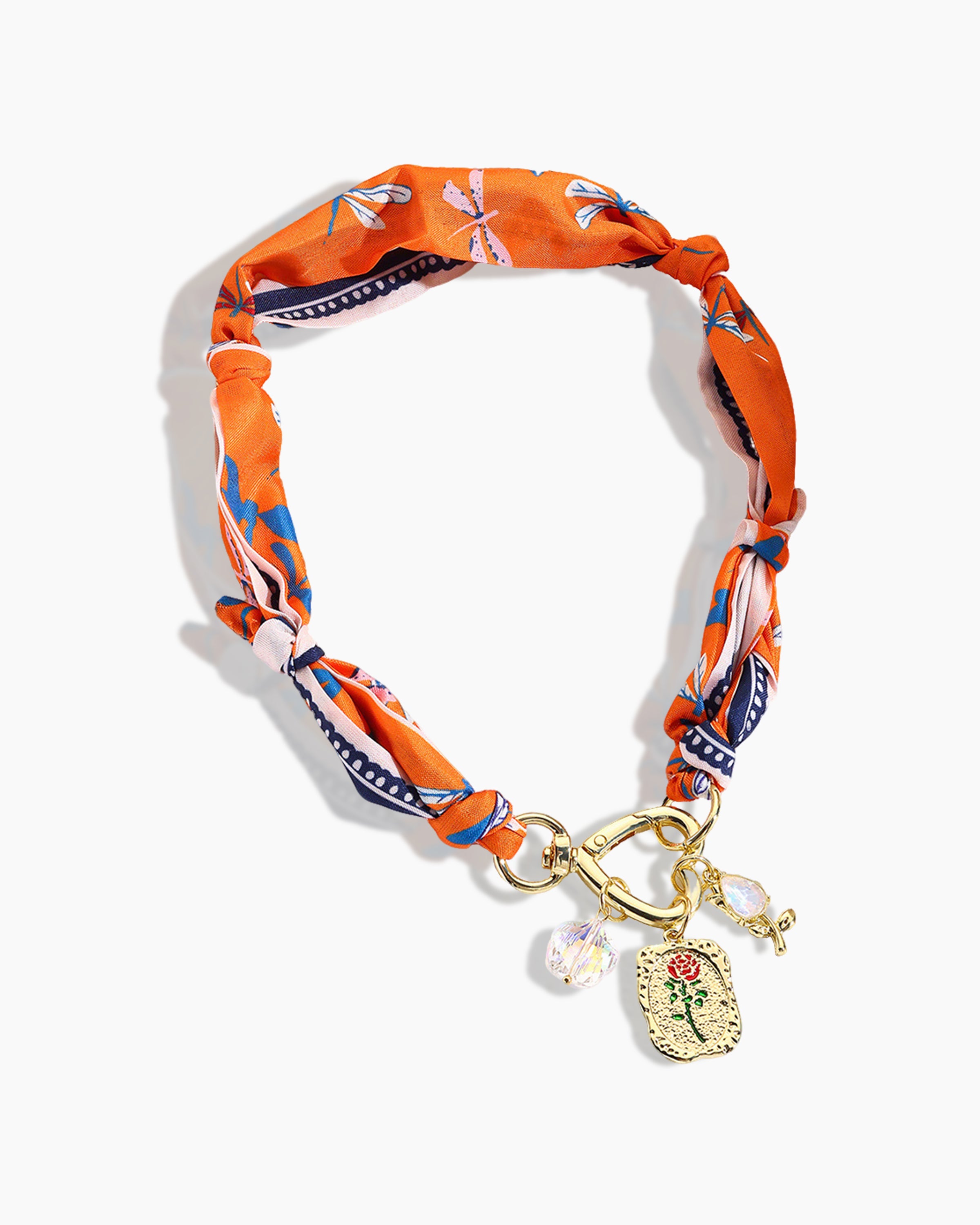 Close-up of heart-shaped clasp, rose decoration, and diamond on silk cat collar